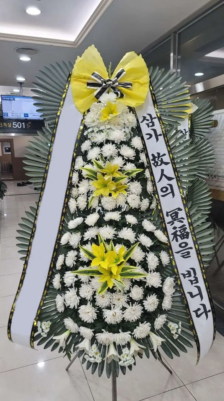 Flowers Beside the Memorial Portrait: A Quiet Way of Showing Care