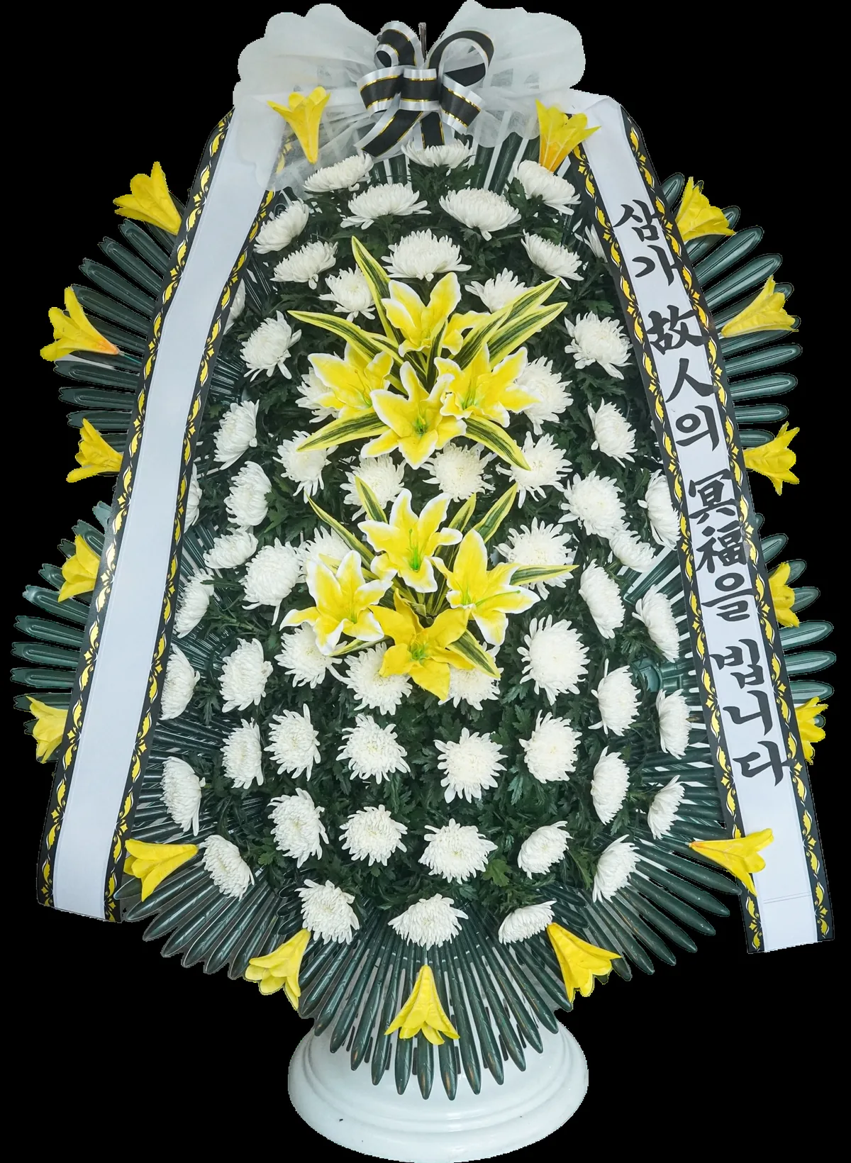 Tall sympathy arrangement of white chrysanthemums and yellow lilies on a white pedestal base, with a sheer white bow and a sash