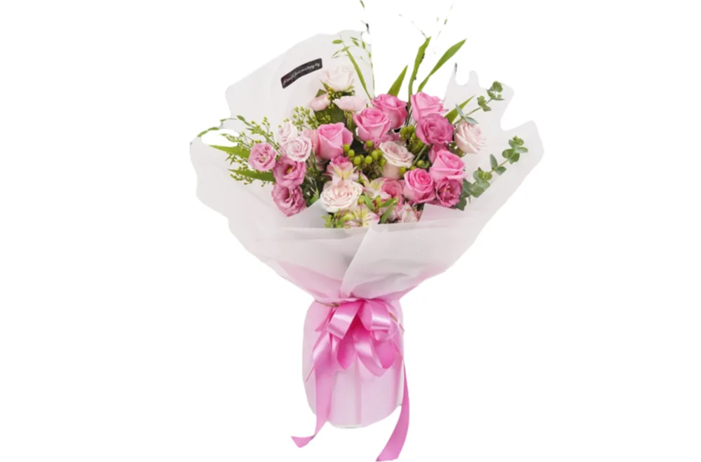 Pink rose and lisianthus bouquet with eucalyptus in a sheer white wrap tied with a pink satin bow