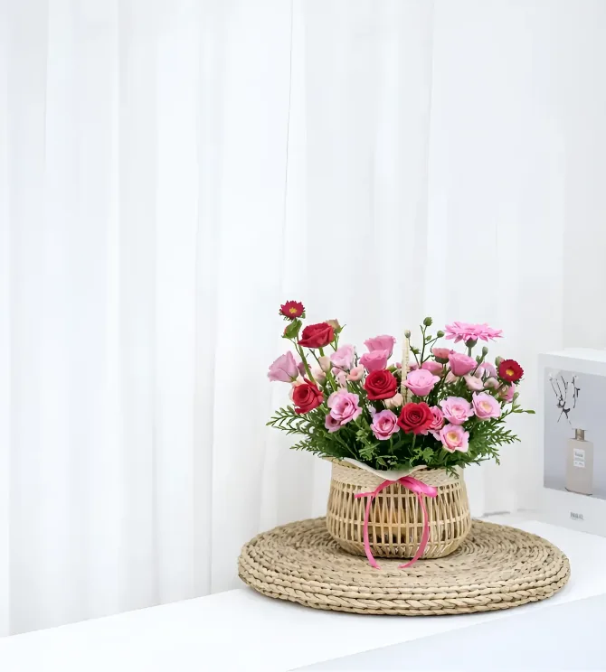 Romantic Pink basket on a woven mat by a white curtain
