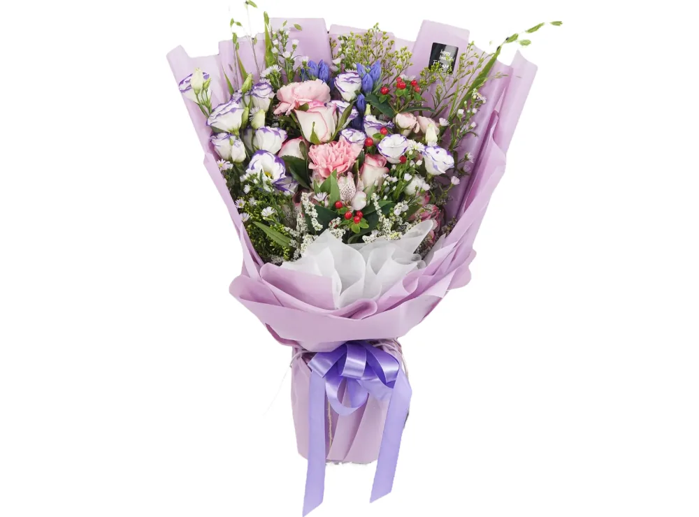 Bouquet of white lisianthus with purple edges, pink carnations, blush roses, blue gentian, red berries and white fillers in lavender wrapping with a purple ribbon