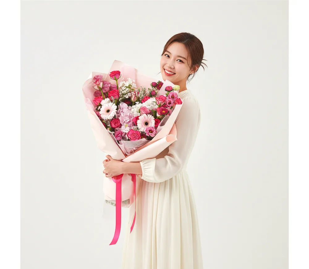 Woman holding the Filled with Love bouquet in a studio