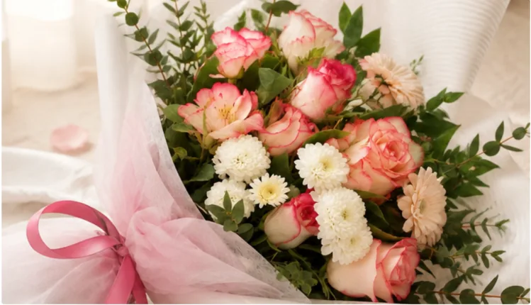 Close-up of the Pink Promise bouquet showing pink-edged roses, white chrysanthemums and a pink ribbon bow